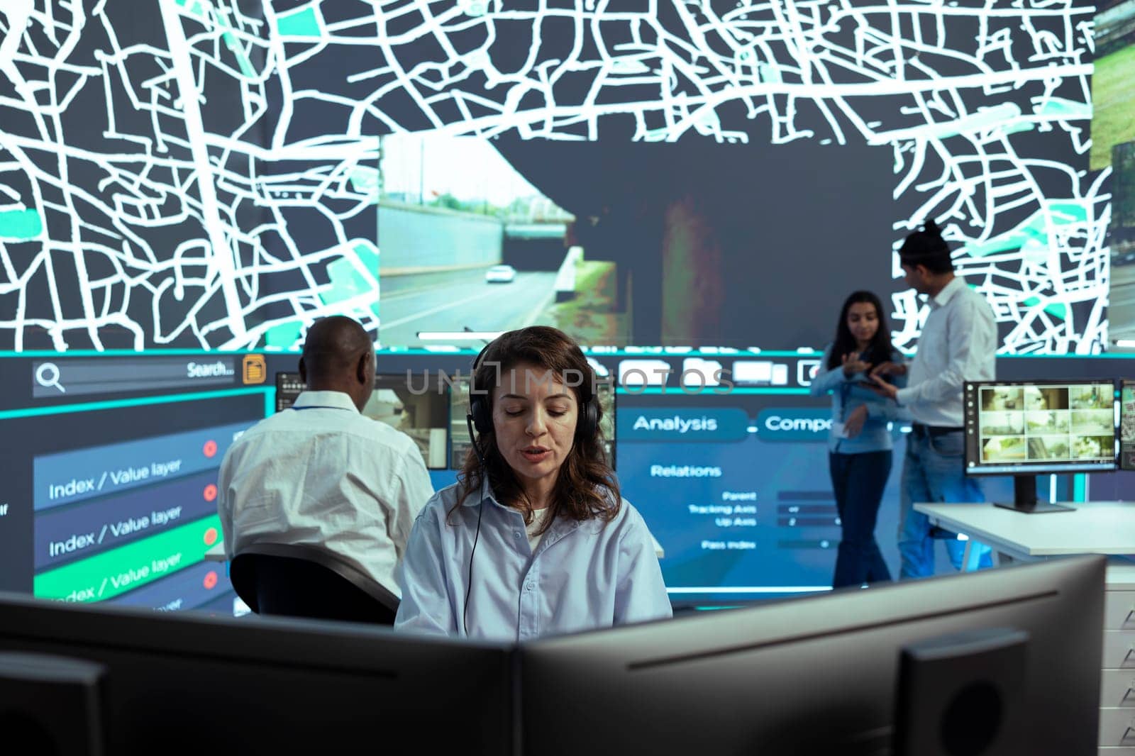 Female employee operates on satellite map CCTV radar to monitor delivery trucks by DCStudio