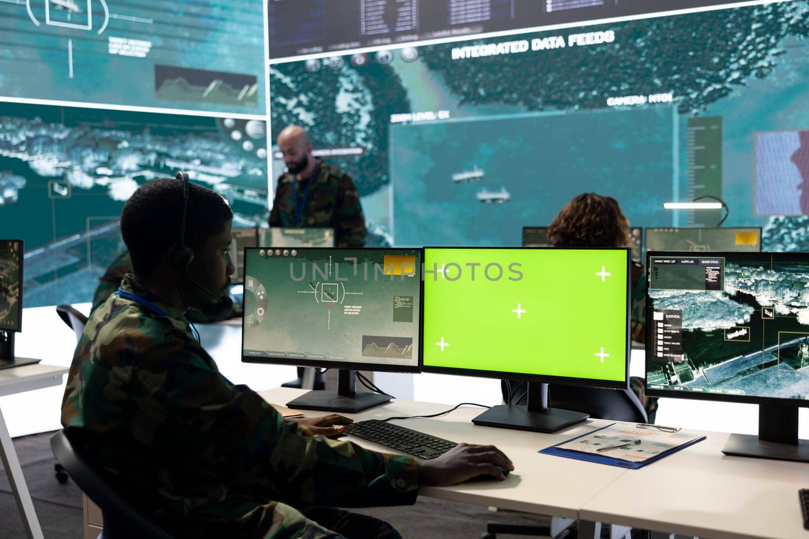 Army personnel monitors isolated green screen and surveillance footage by DCStudio