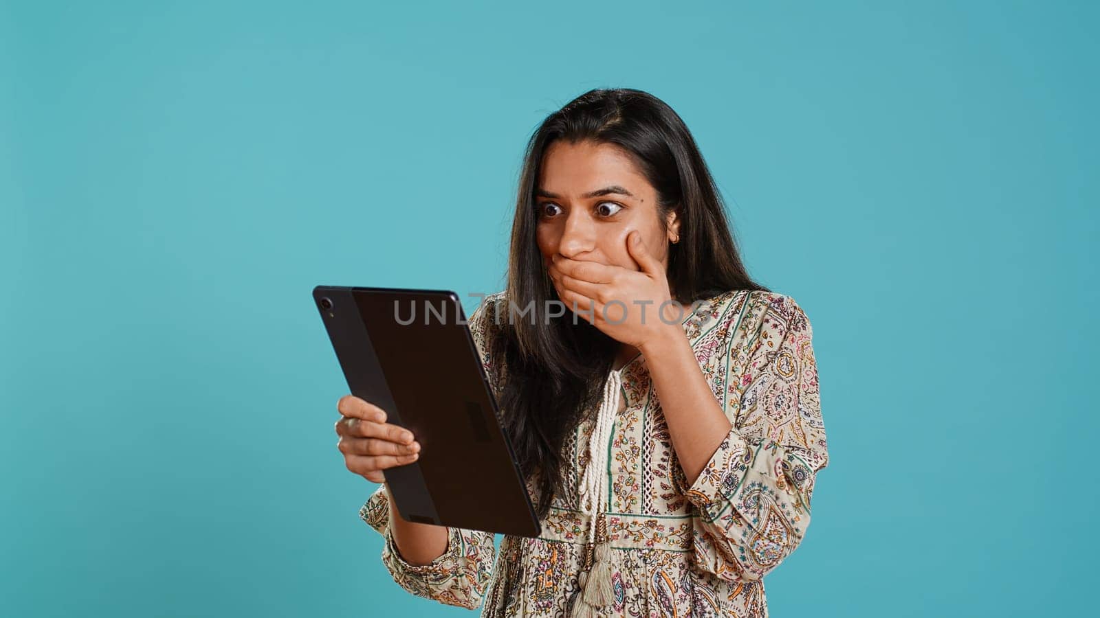 Cheerful woman gossiping with friends during videoconference by DCStudio