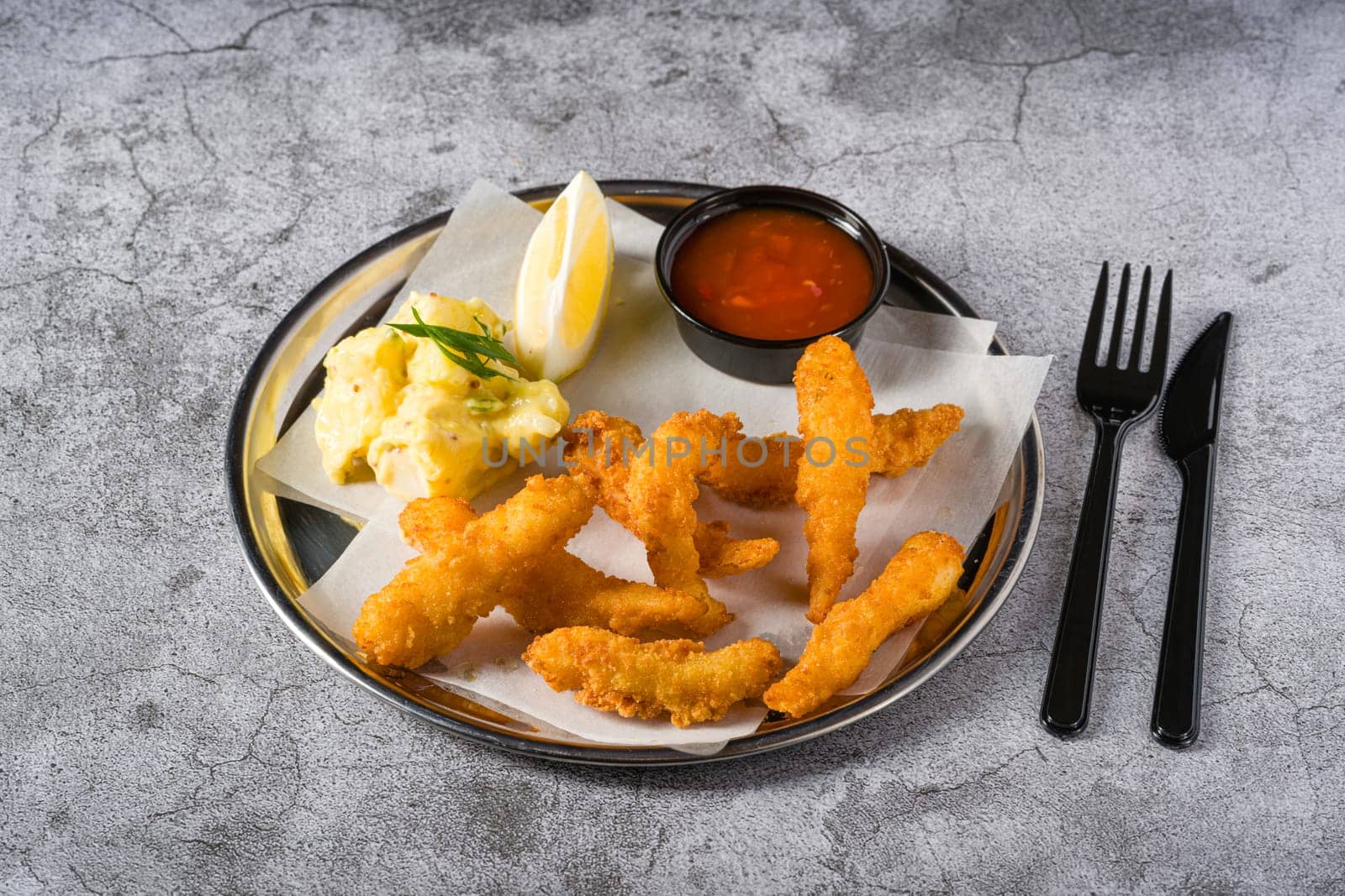 Deep fried shrimp tempura with potato salad on a metal plate by Sonat