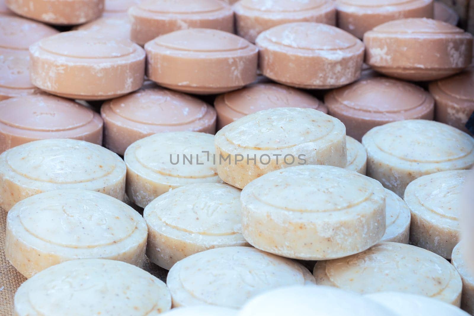 Savon de Marseille in french and grated soap on the cotton towel with clothes pegs and washing brush at home laundry close up.