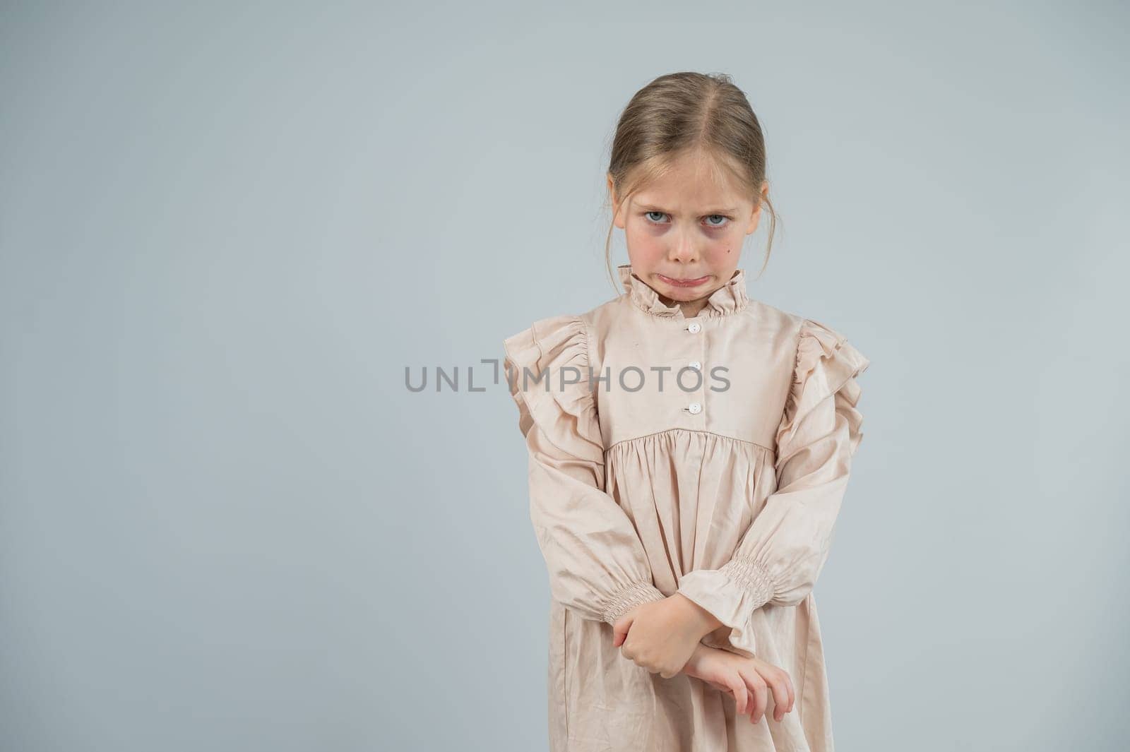 Portrait of a dissatisfied Caucasian girl on a white background