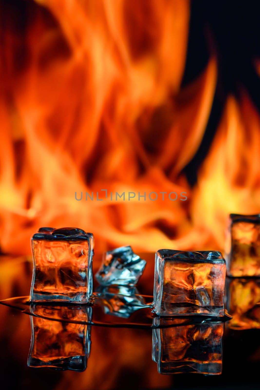 three ice cubes against the background of fire, fire and ice, place under the text 1