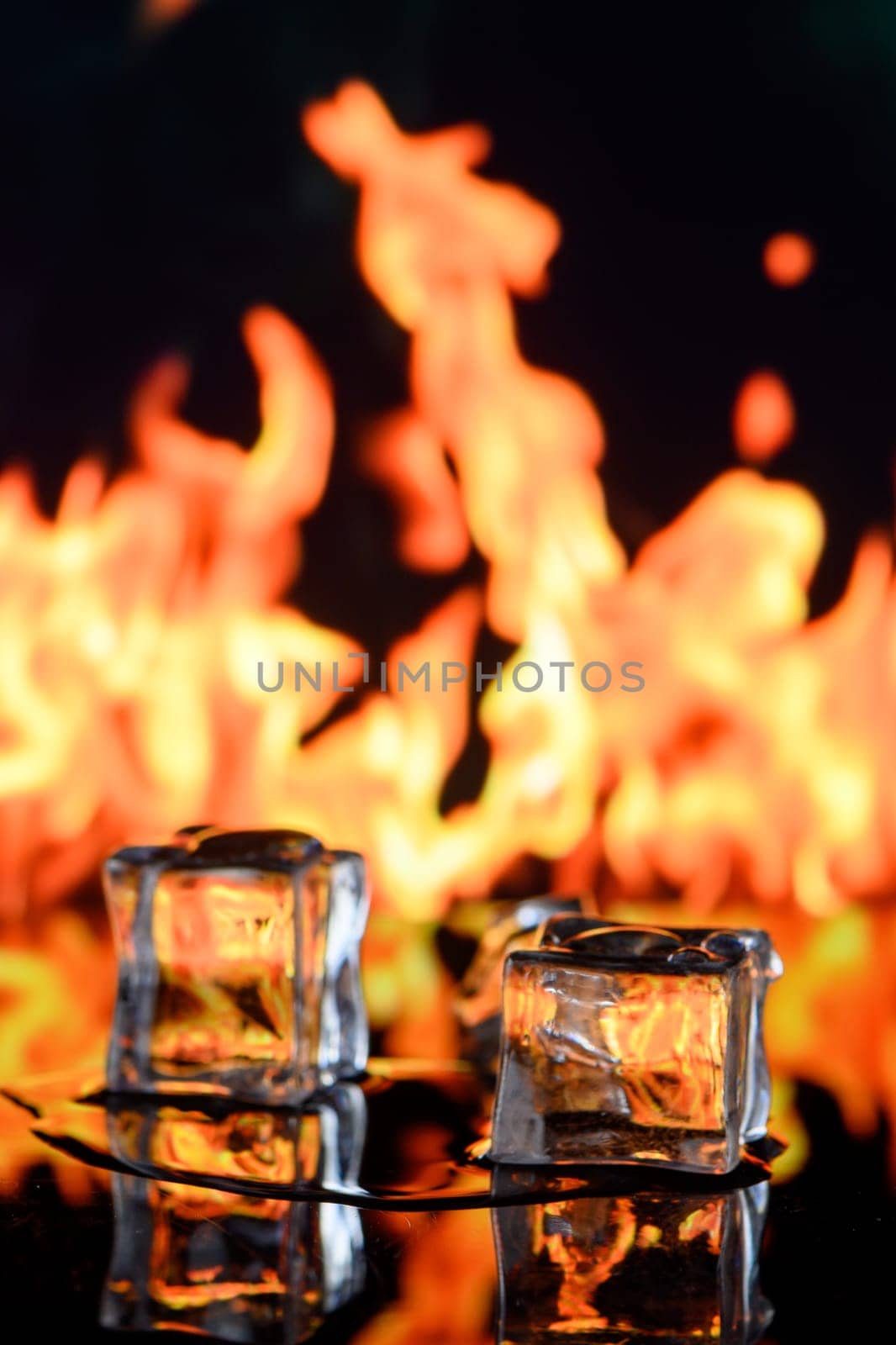 cubes of ice and fire on a water surface on an abstract background by Mixa74