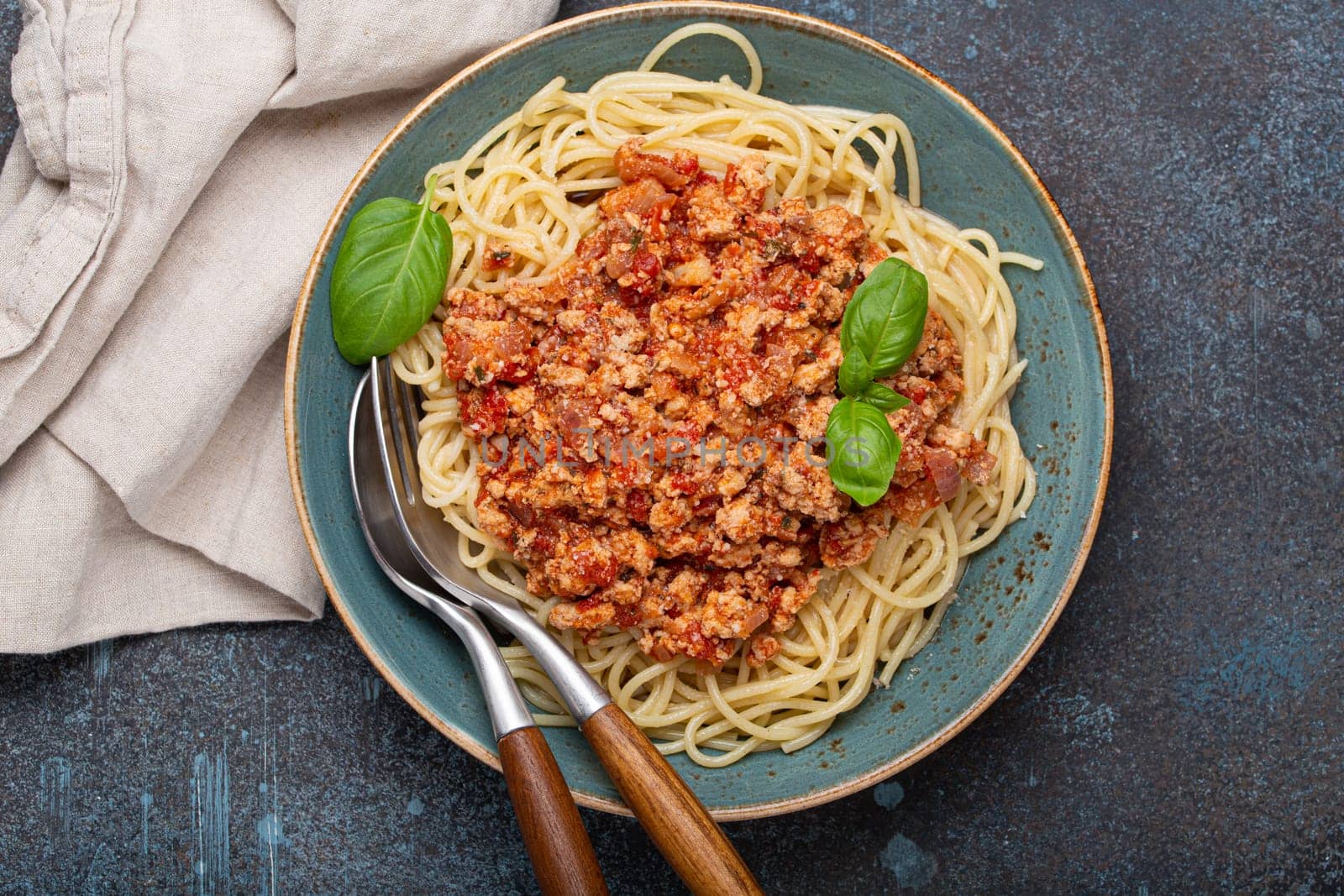 Delicious spaghetti with bolognese sauce served on rustic plate by its_al_dente