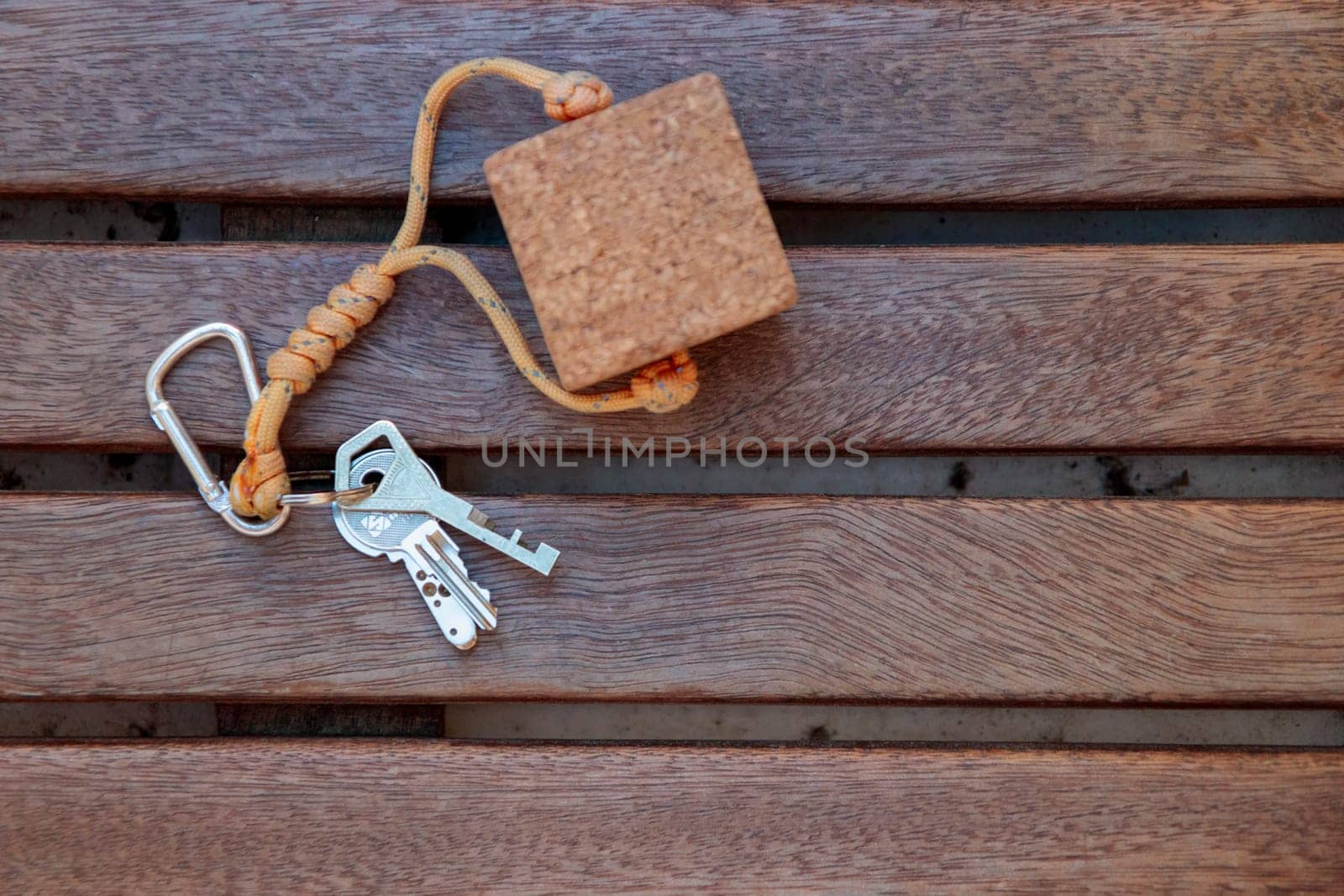 Brown cork floating boat trinket with yacht's keys on the wooden sailboat, top view with copy space