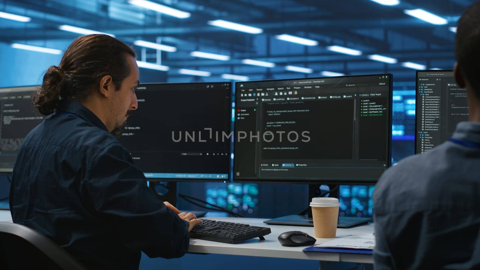 Men coding together in high tech server hub, using computers to analyze data, by DCStudio