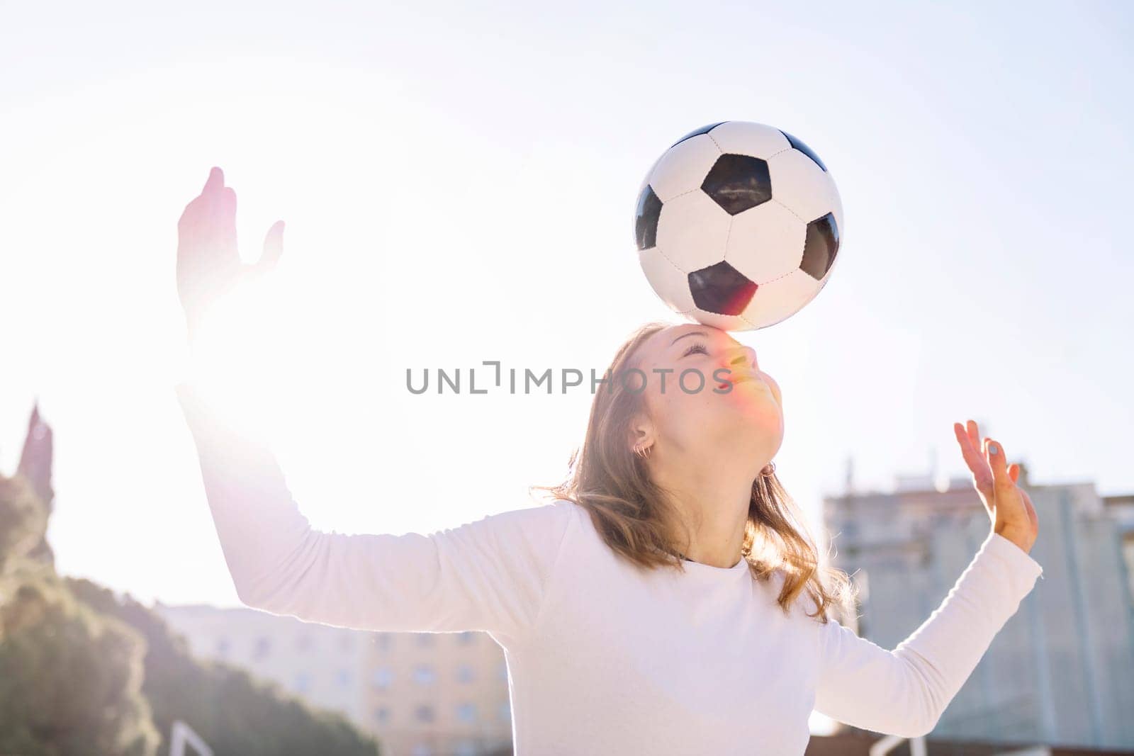 young caucasian woman head touching a soccer ball, concept of sport and football lifestyle