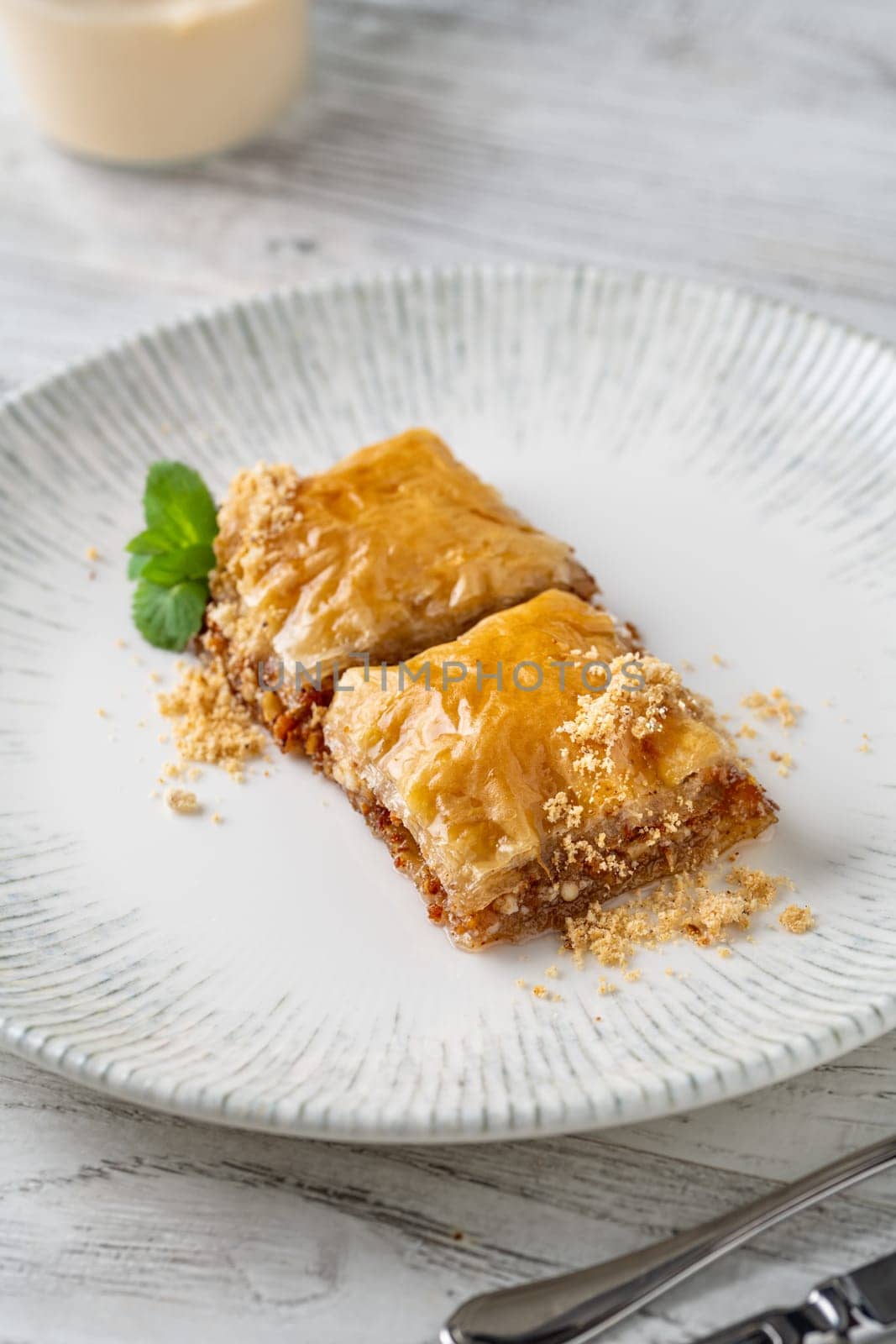 Traditional Turkish dessert walnut baklava on a white porcelain plate