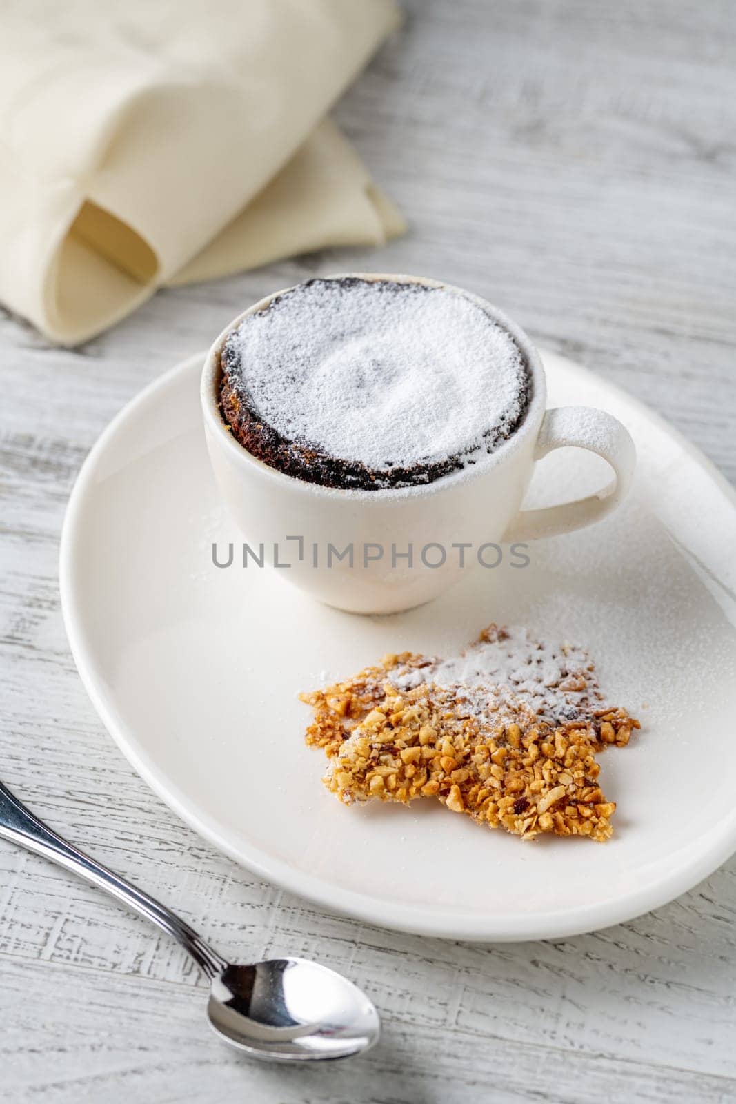 Chocolate souffle with flowing chocolate on a white porcelain plate
