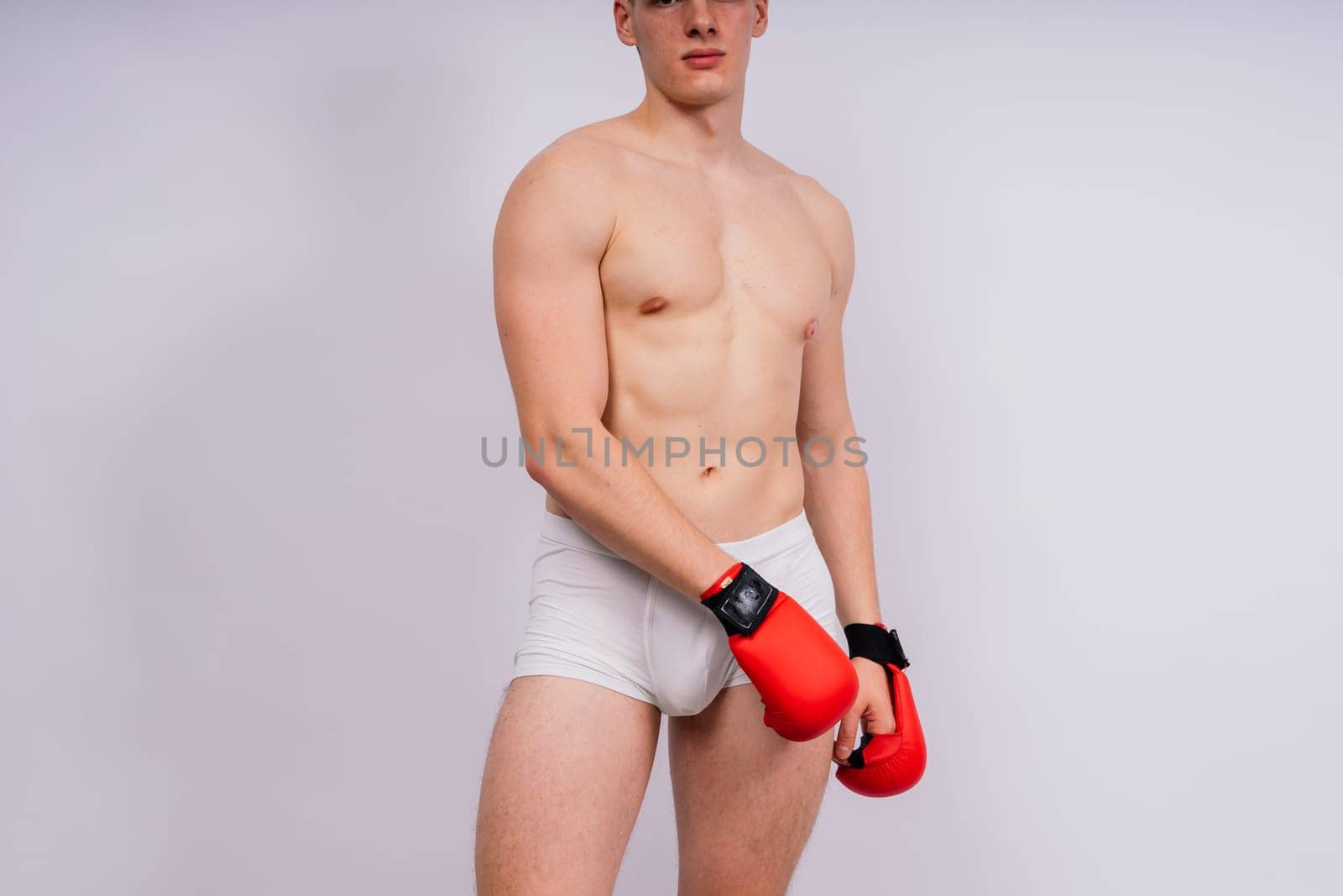 Studio shot of athlete boxer training. Concept of sport, healthy lifestyle. Red sportswear. by Zelenin