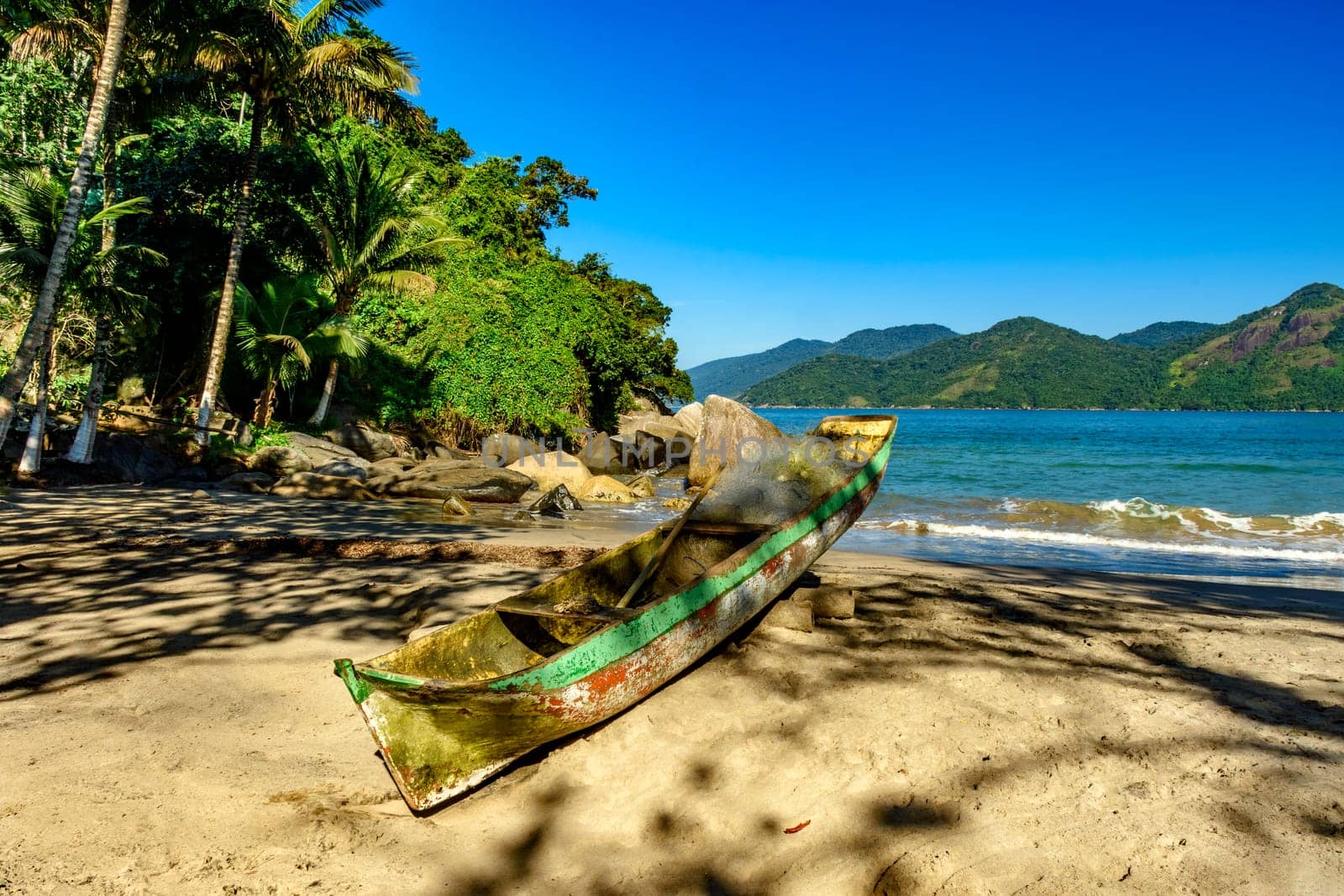 Fishing canoe over beach sand by Fred_Pinheiro