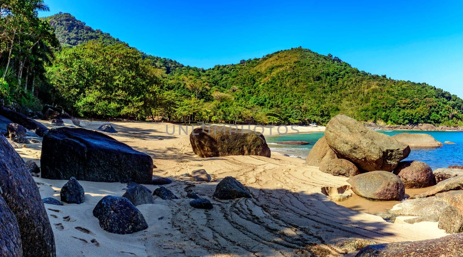 Forest,  hill, rocks and sea of stunning Indaiauba beach in Ilhabela island coast os Sao Paulo