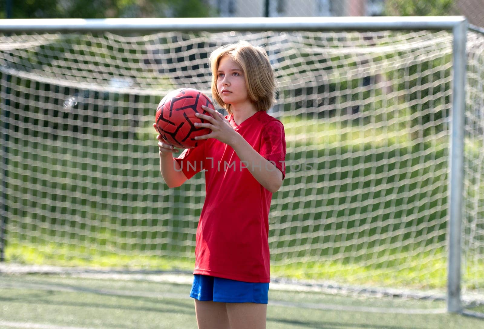 Girl Goalkeeper Stands At Goalposts During Children'S Football Match