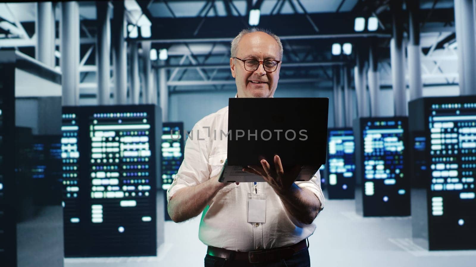 Meticulous employee expertly managing data while navigating in industrial server room. Precise worker in high tech facility ensuring optimal cybersecurity protection, optimizing systems
