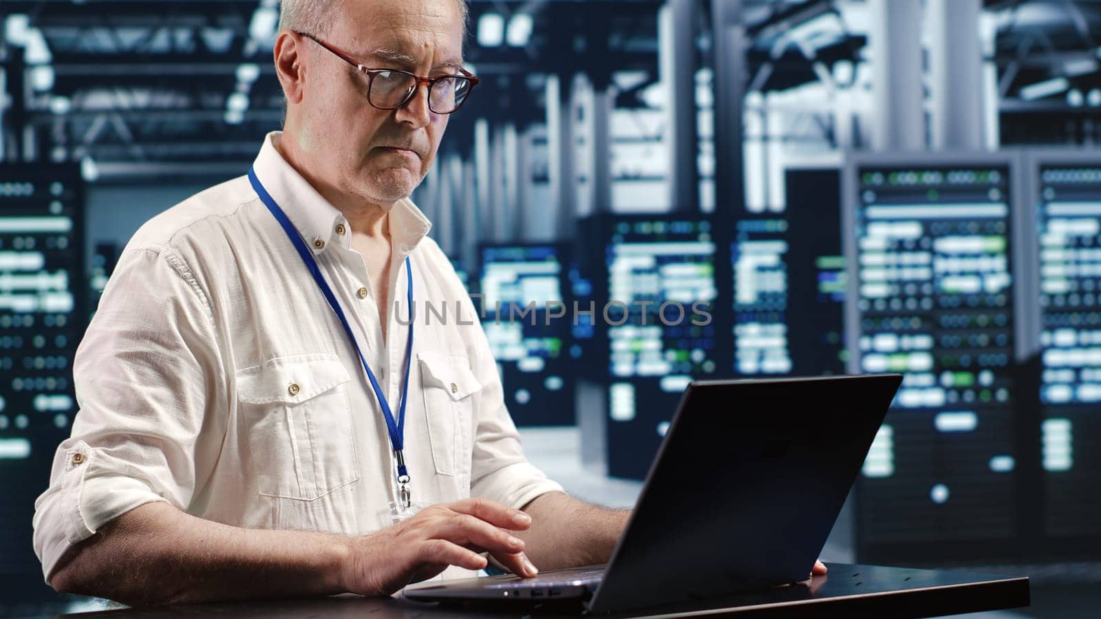 Licensed serviceman expertly managing data while navigating in industrial server room. Tech support executive ensuring optimal cybersecurity protection, optimizing systems