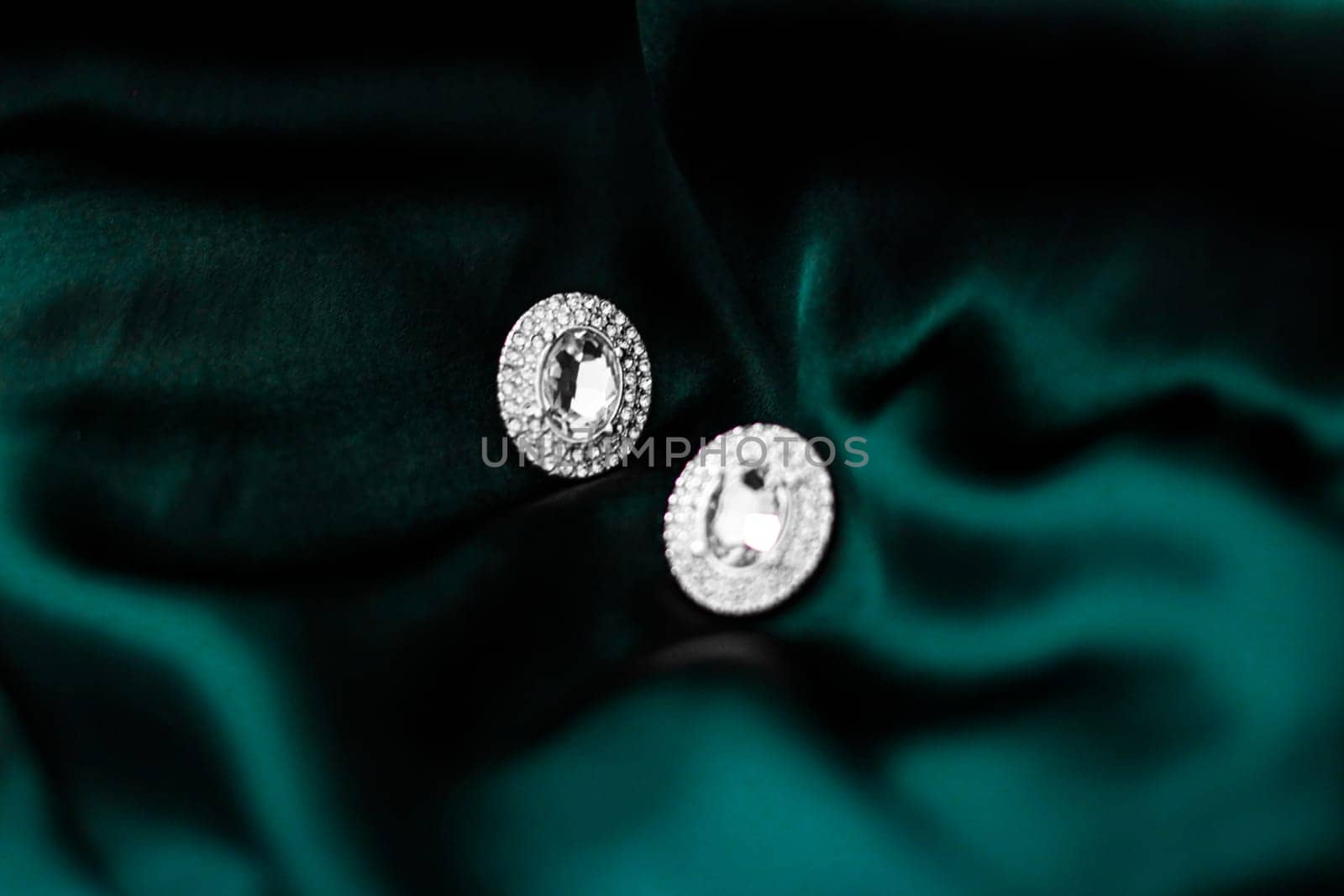 Jewellery brand, elegant fashion and bridal luxe gift concept - Luxury diamond earrings on dark emerald green silk, holiday glamour jewelery present