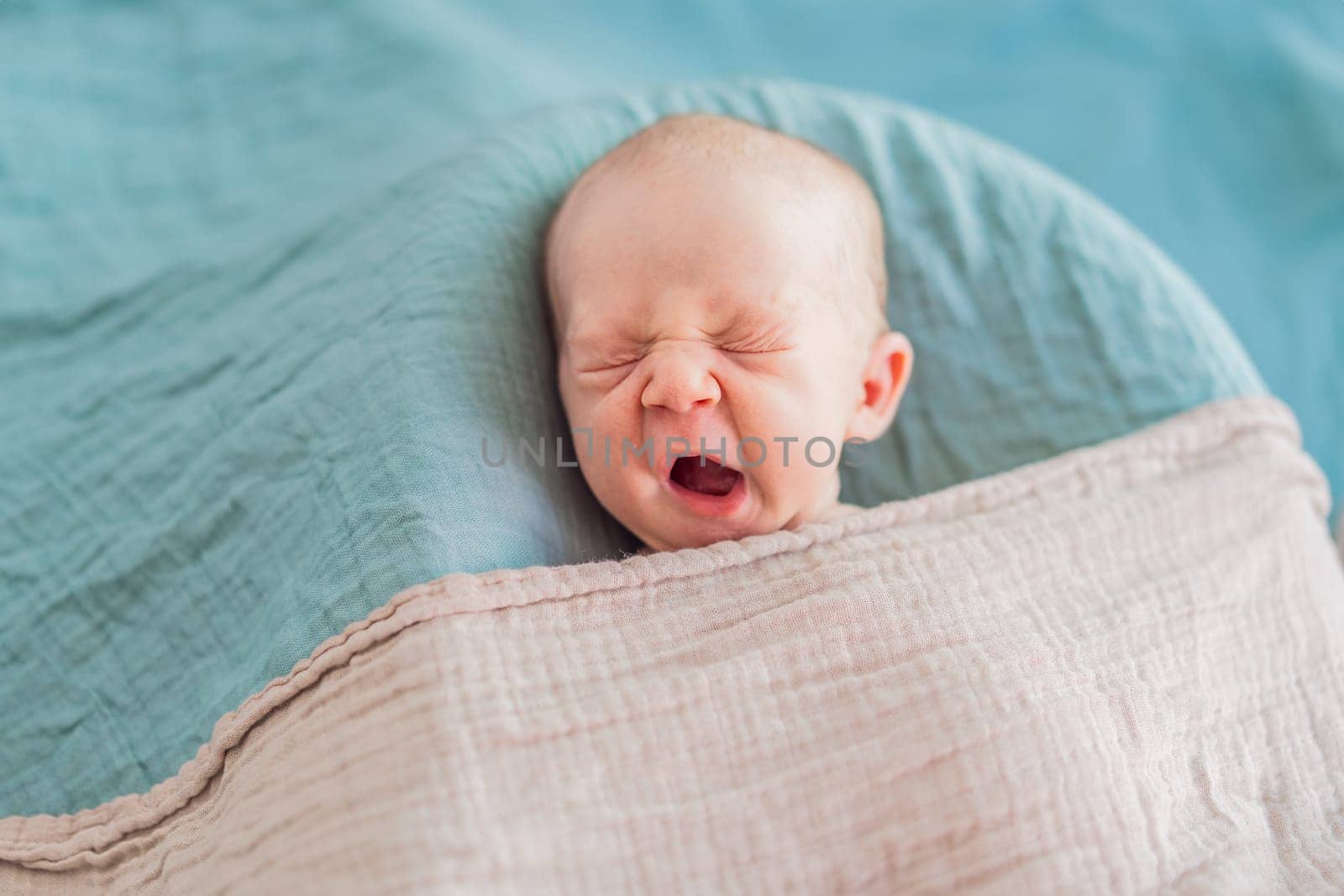 The baby is sleeping peacefully in his cozy nest. Newborn photo session captures the serene innocence and warmth of early moments.