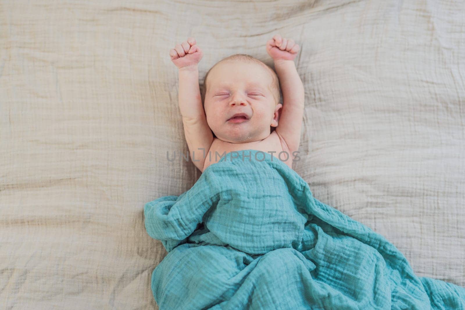 The baby is sleeping peacefully in his cozy nest. Newborn photo session captures the serene innocence and warmth of early moments.