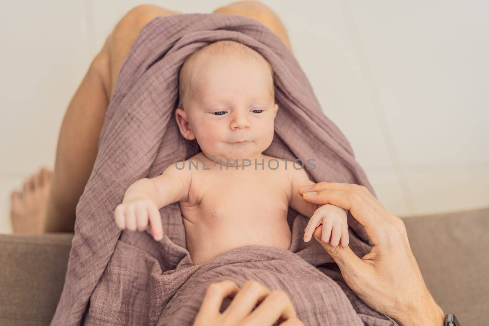 Dad and newborn at home. This tender moment captures the bond between father and child in a loving and comfortable family environment highlighting the joys of parenthood and the warmth of home.