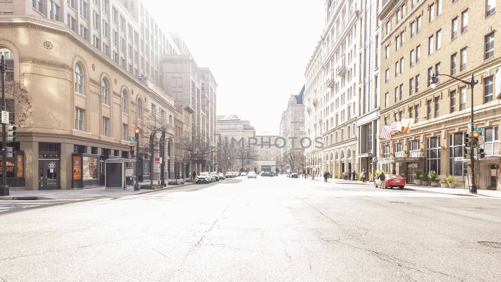 This atmospheric photo captures an eerie, desolate city street devoid of any signs of life. The empty road stretches into the distance, creating a sense of abandonment and solitude.