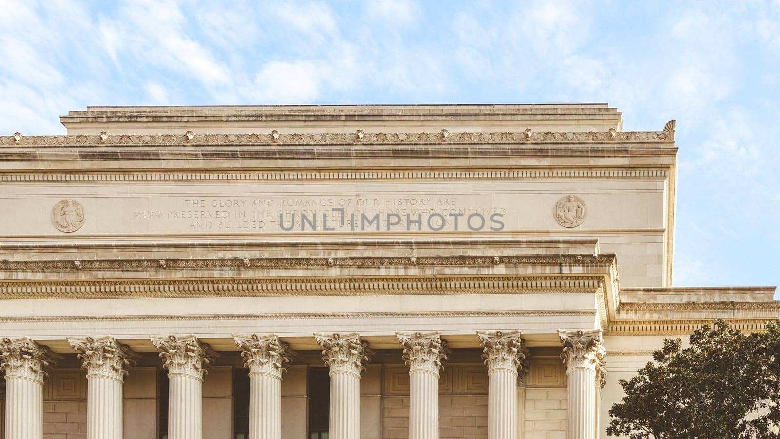 The grand government building features a row of columns, showcasing power and authority. Its design blends classical and neoclassical styles, symbolizing strength and stability.