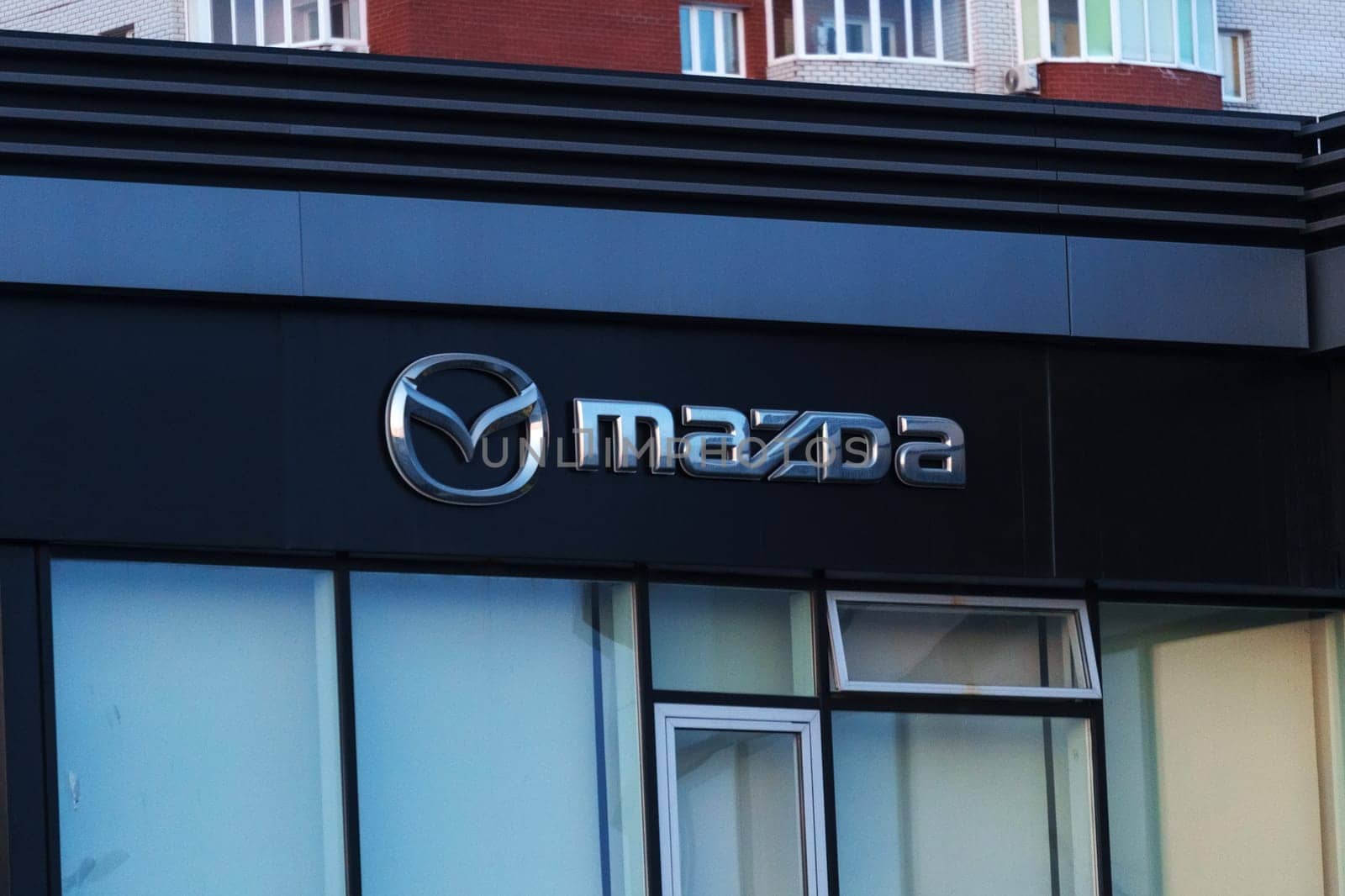 Tyumen, Russia-March 18, 2024: Mazda logo is prominently featured on the side of a building, standing out against the background.