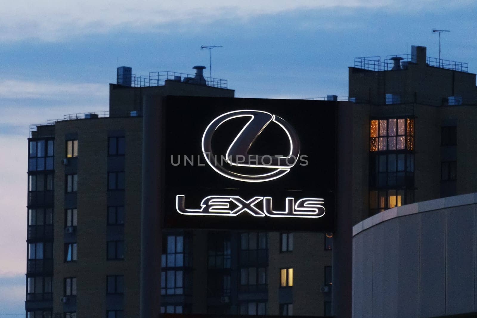 Tyumen, Russia-March 18, 2024: Sign displaying the Lexus logo on the side of a building, indicating a dealership or service center for the luxury car brand.
