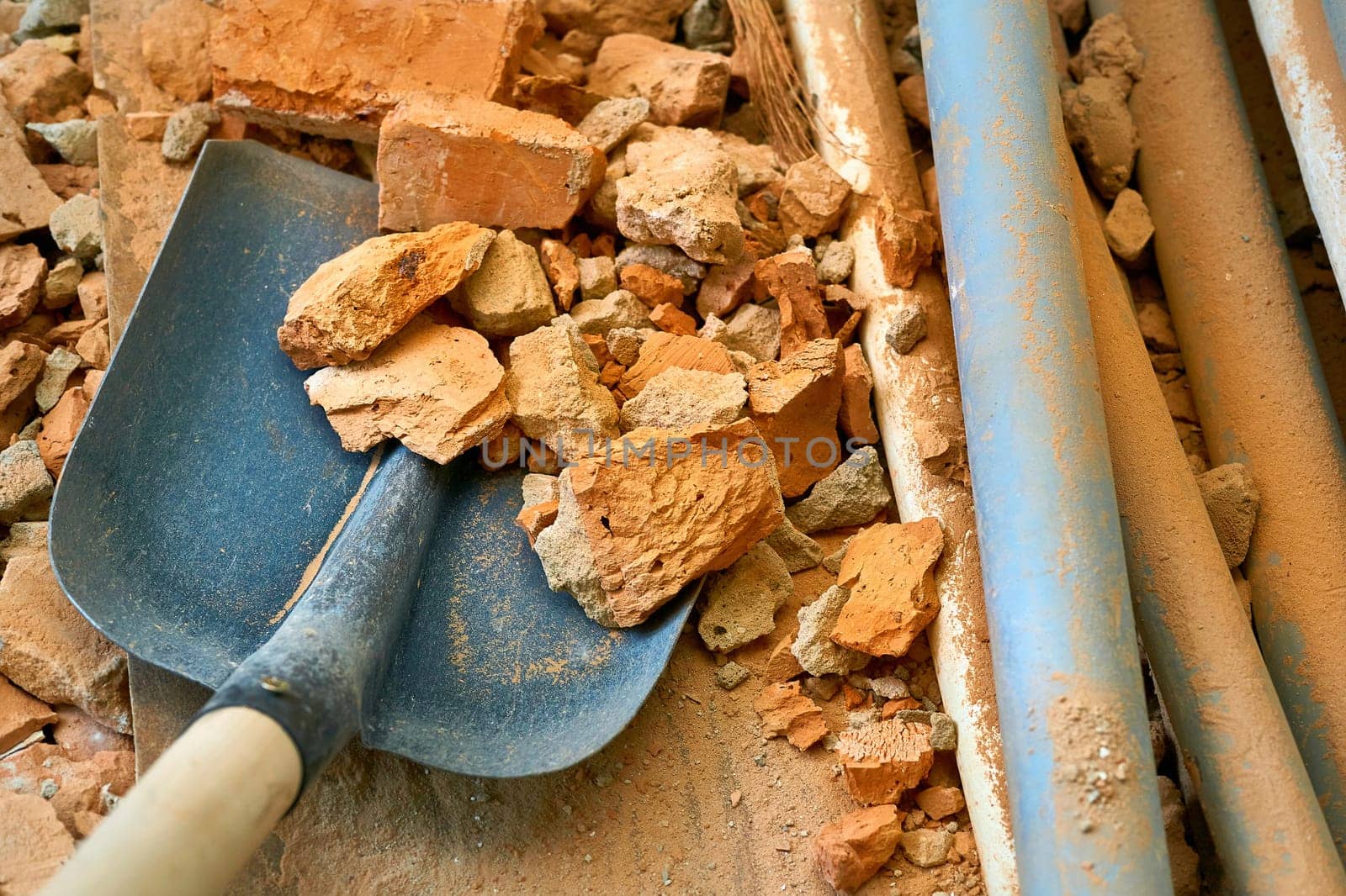 Scoop shovel on garbage broken brick collection at construction site, repair by jovani68