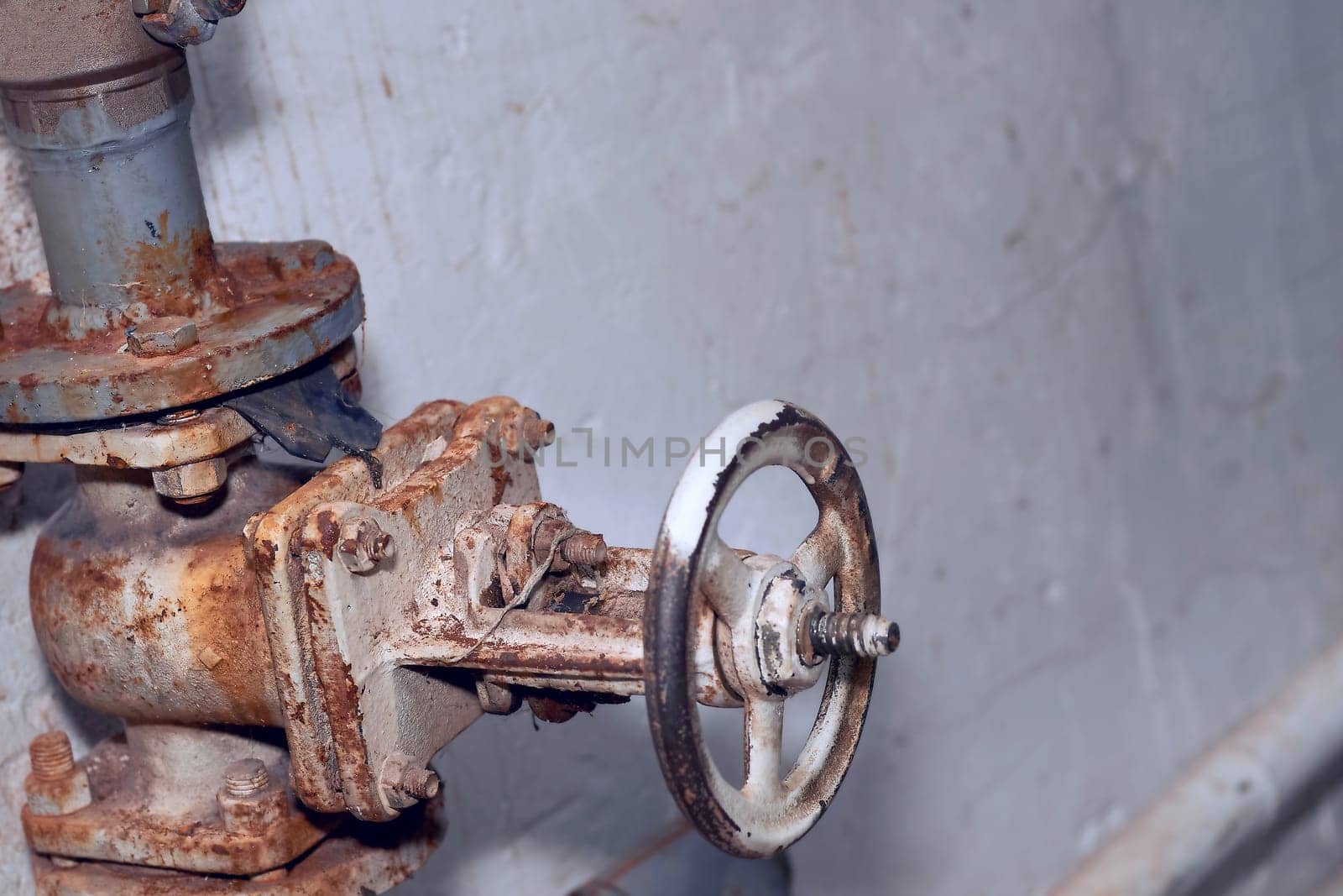 Plumbing. Sewage. Water valve, old rusty faucet in the basement by jovani68