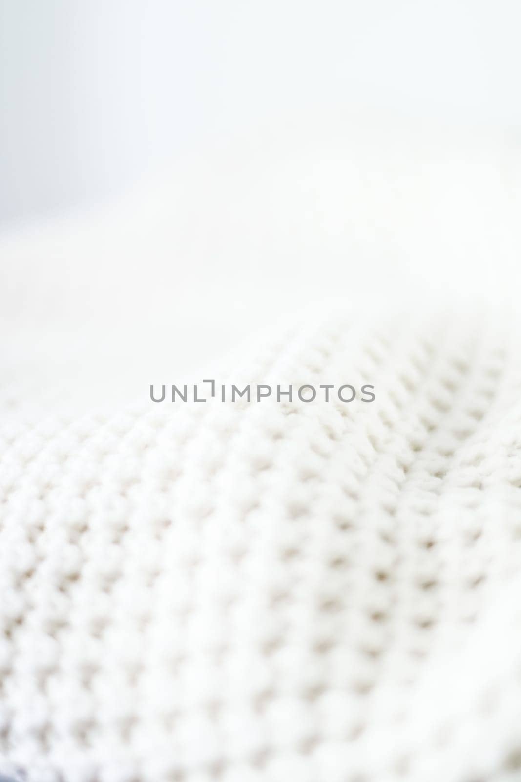 Knitwear, fabric textures and handmade items concept - Warm knitted clothes, soft and white