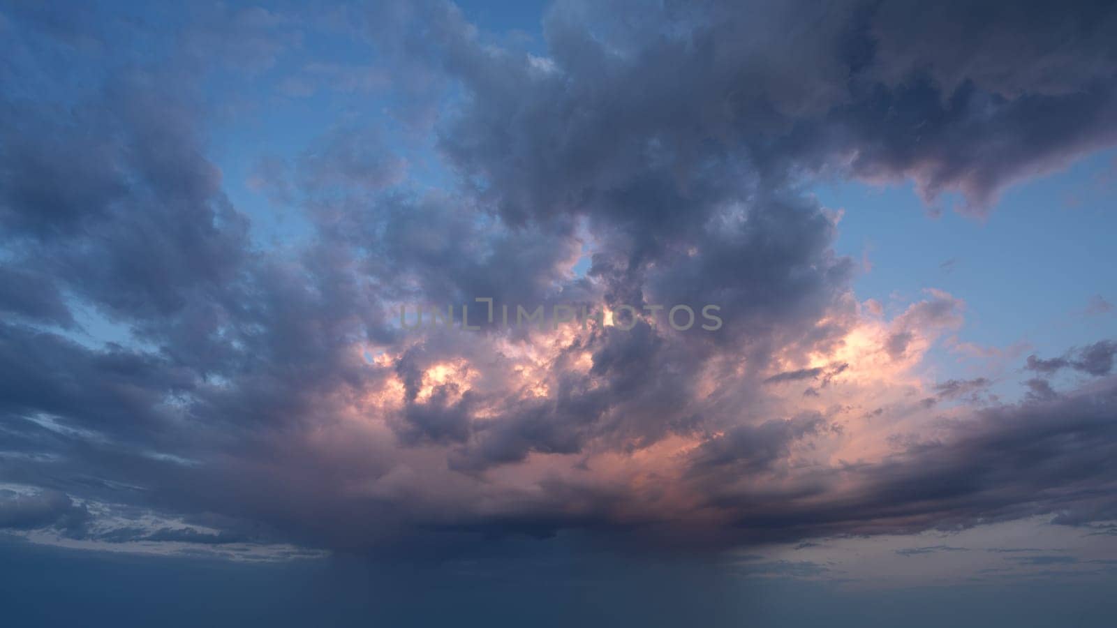 Low angle view to evening sky with dramatic clouds