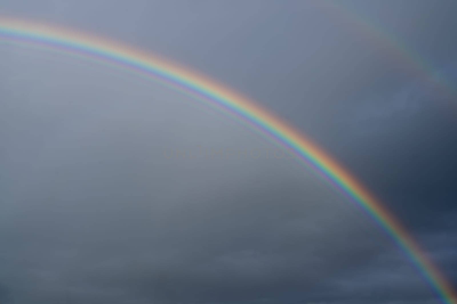 Low angle view to sky with rainbow