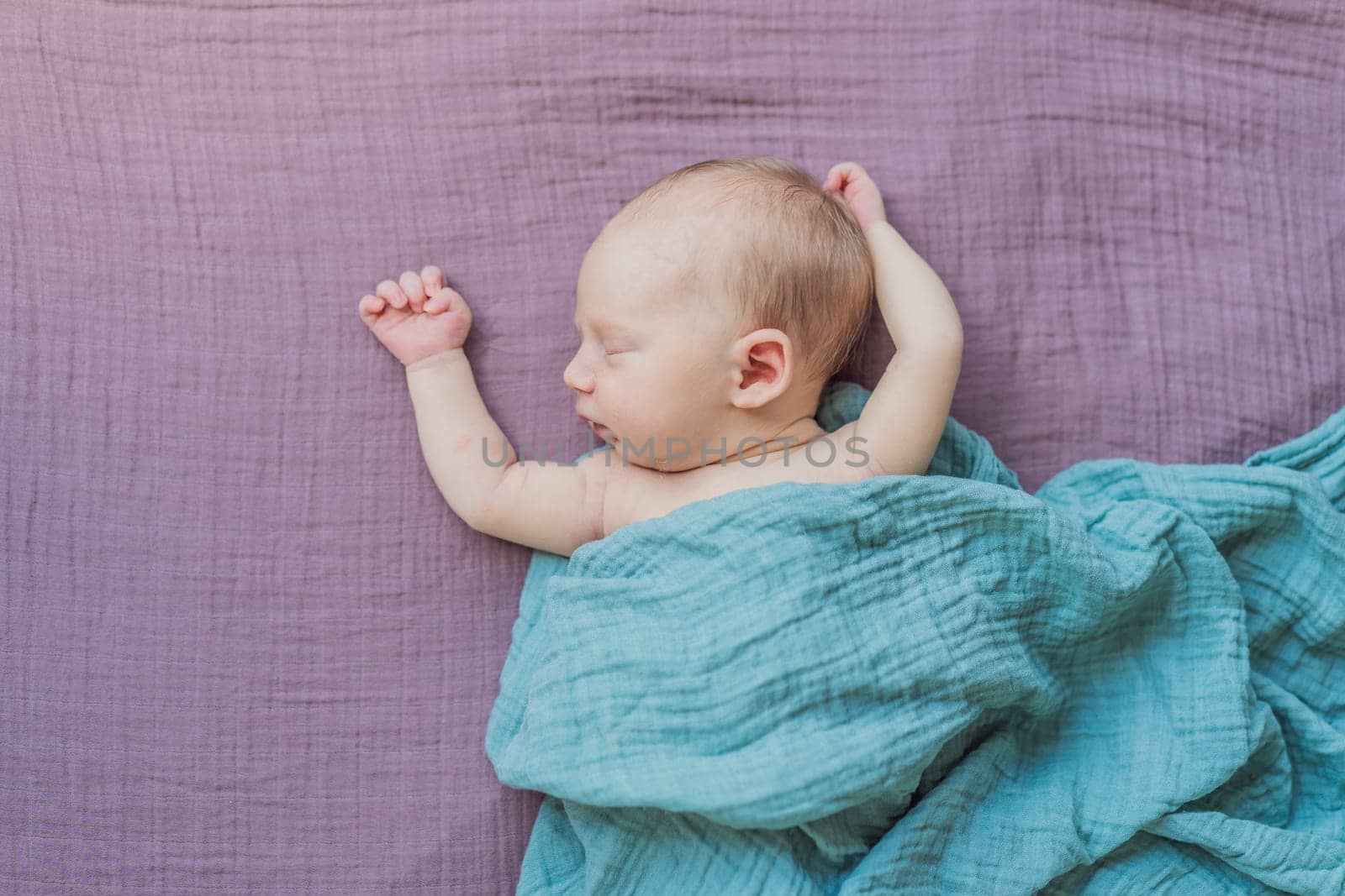 The baby is sleeping peacefully in his cozy nest. Newborn photo session captures the serene innocence and warmth of early moments.