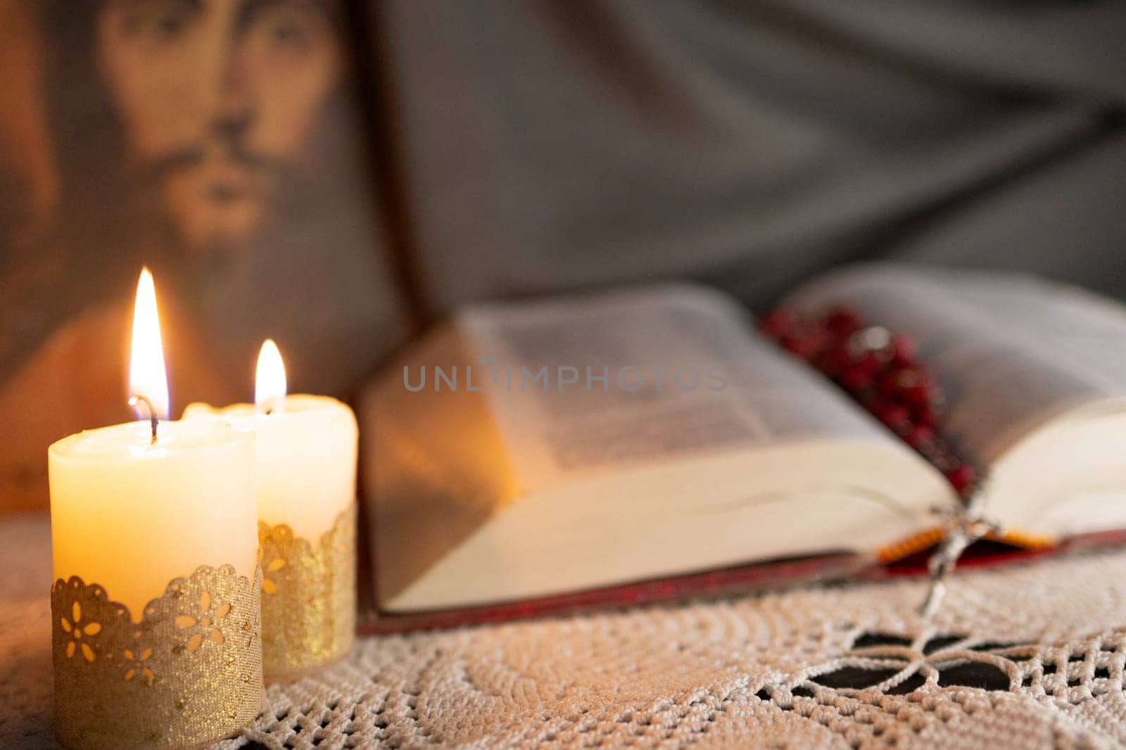 Bible and rosary illuminated by candlelight.Culture of faith by VeroDibe