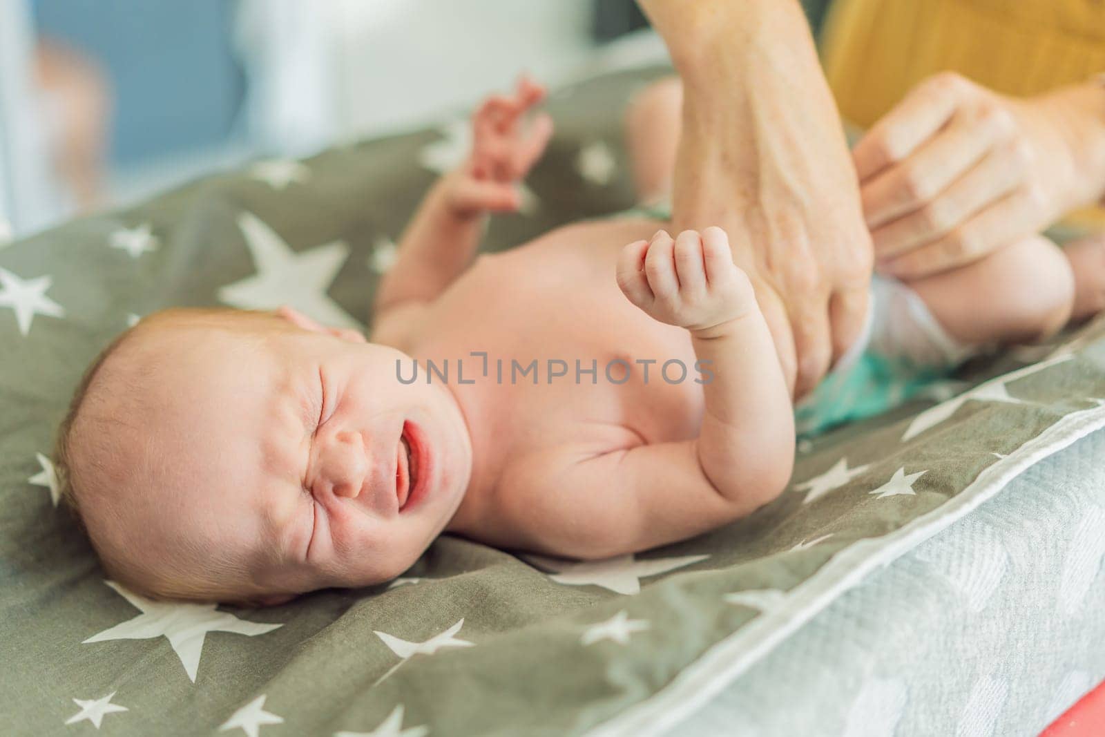 The newborn's skin is peeling. Mom uses skin products and massages to care for and soothe the baby's delicate skin, ensuring comfort and promoting healthy skin.
