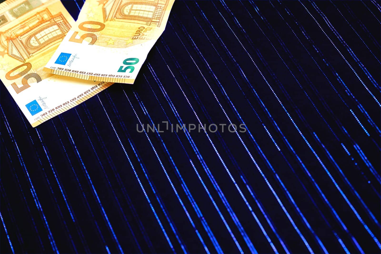 Money. Two 50 euro banknotes on dark blue fabric with lurex by jovani68