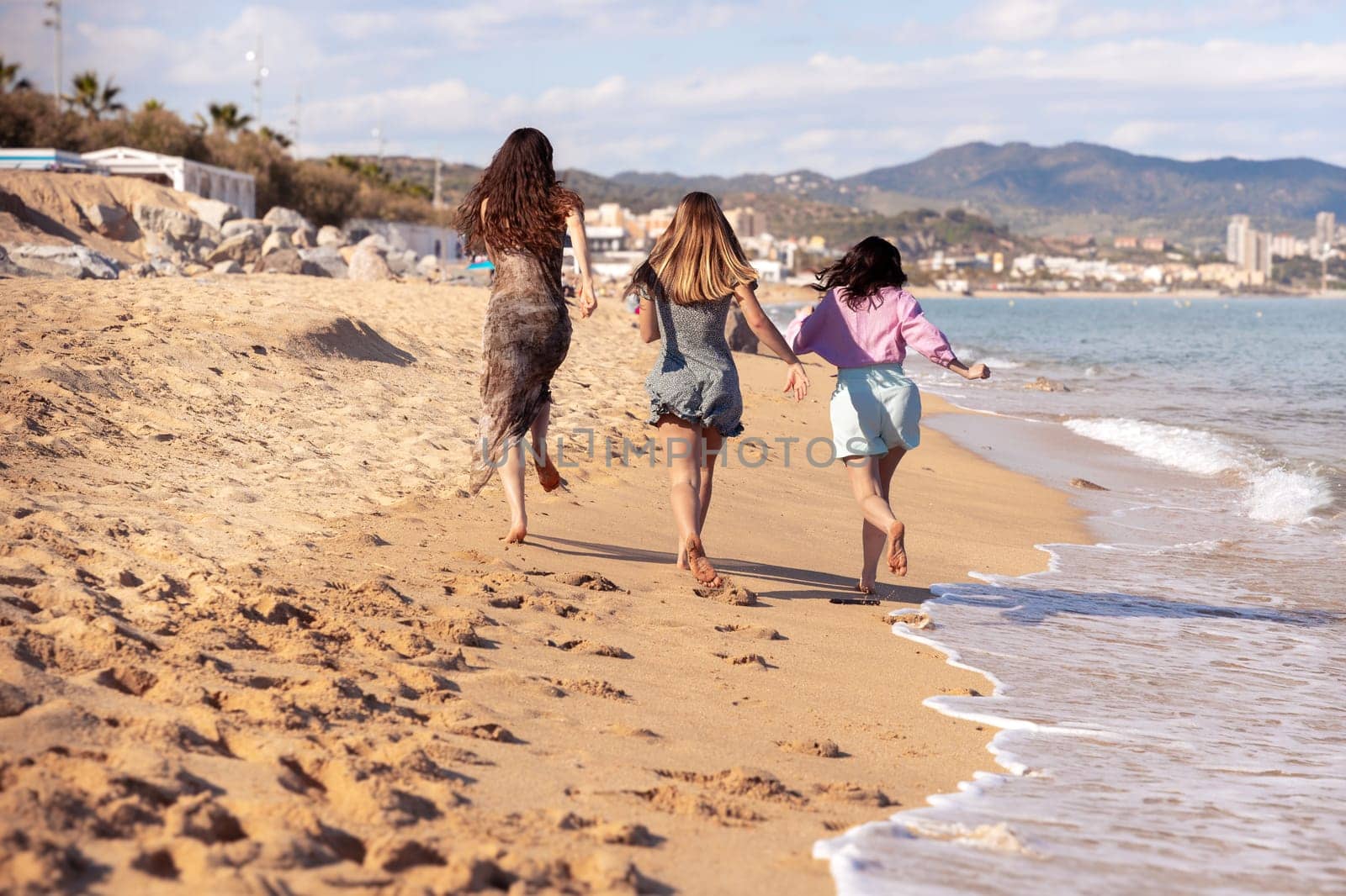 Cheerful multiethnic friends with sunglasses happy on vacation on the beach,