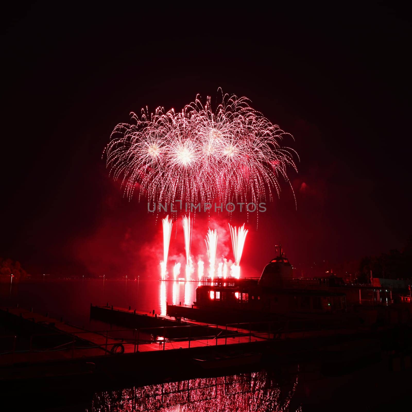 Firework. Beautiful colorful fireworks on the water surface with a clean black background. Fun festival and contest of Firefighters. Brno Dam - Czech Republic. by Montypeter