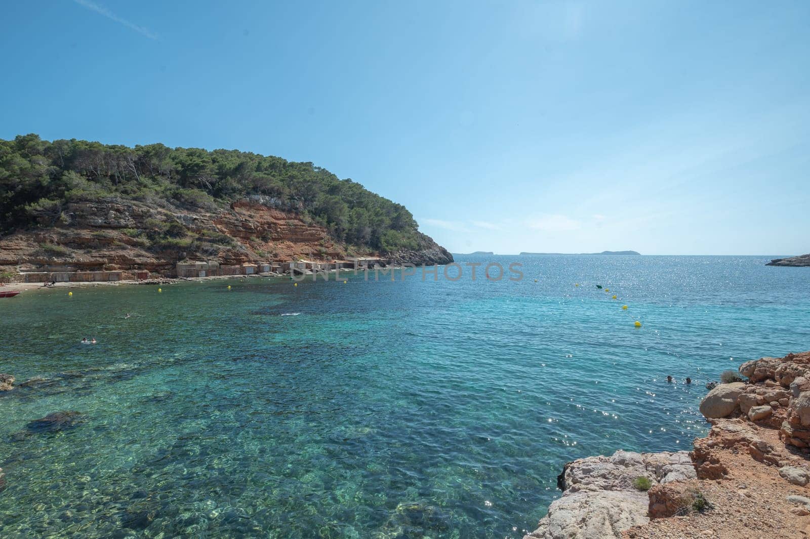 Turquoise waters of Cala Saladeta in Ibiza in summer.