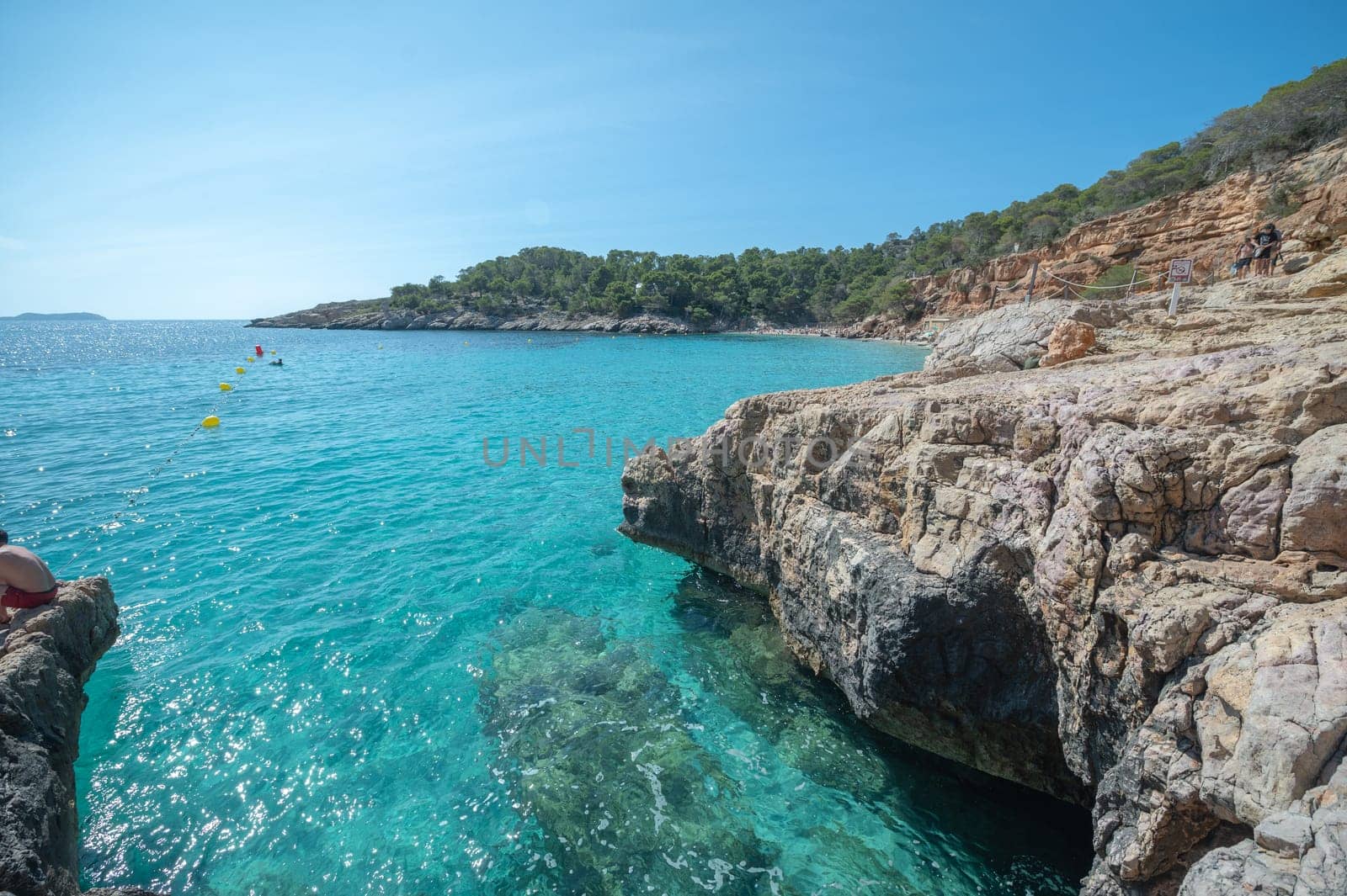 Turquoise waters of Cala Saladeta in Ibiza in summer.