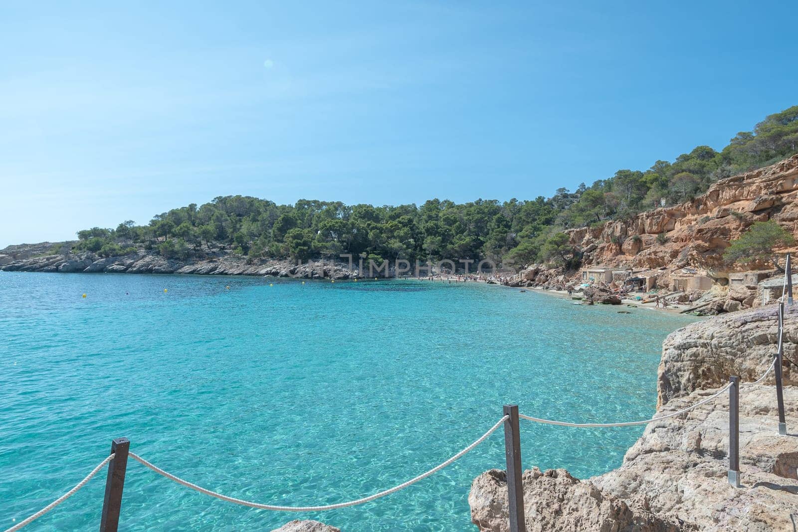 Turquoise waters of Cala Saladeta in Ibiza in summer.