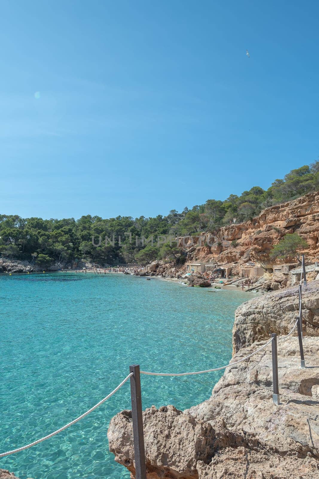 Turquoise waters of Cala Saladeta in Ibiza in summer.