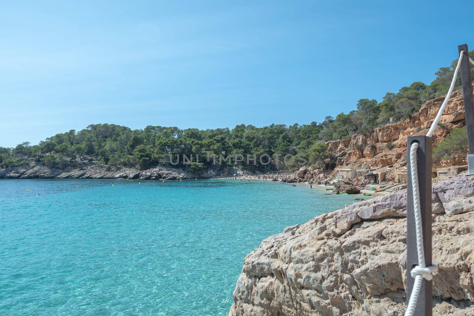 Turquoise waters of Cala Saladeta in Ibiza in summer.