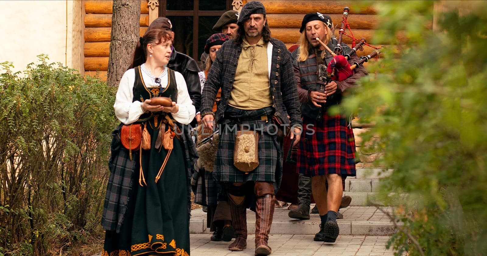 The Scottish Lord of the Clan goes with his people to the ceremony. Scottish bagpiper.