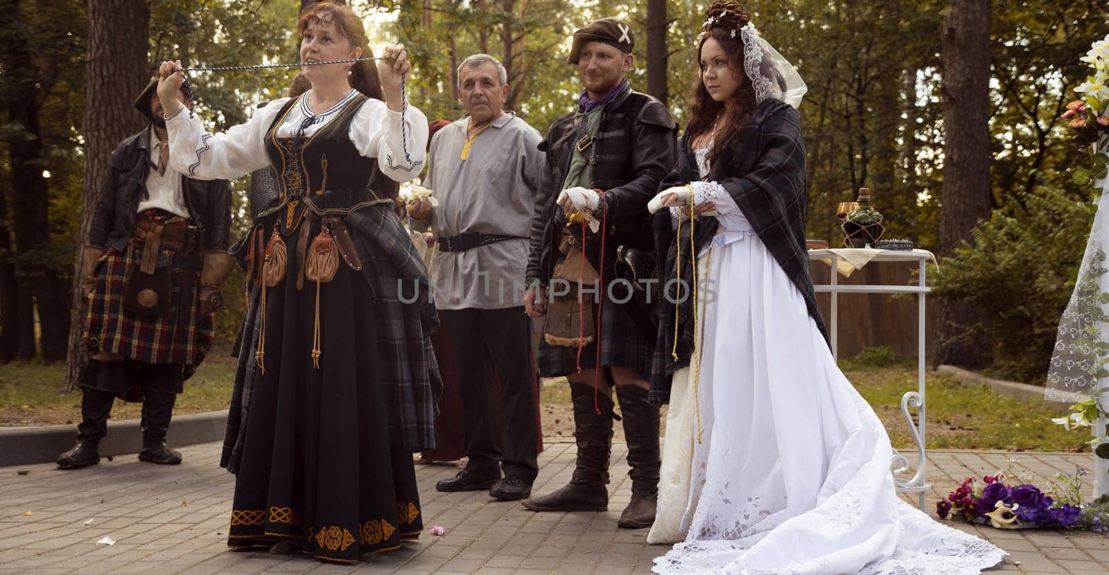 Wedding ceremony. Scottish wedding. Husband and wife are connected by the threads of fate.