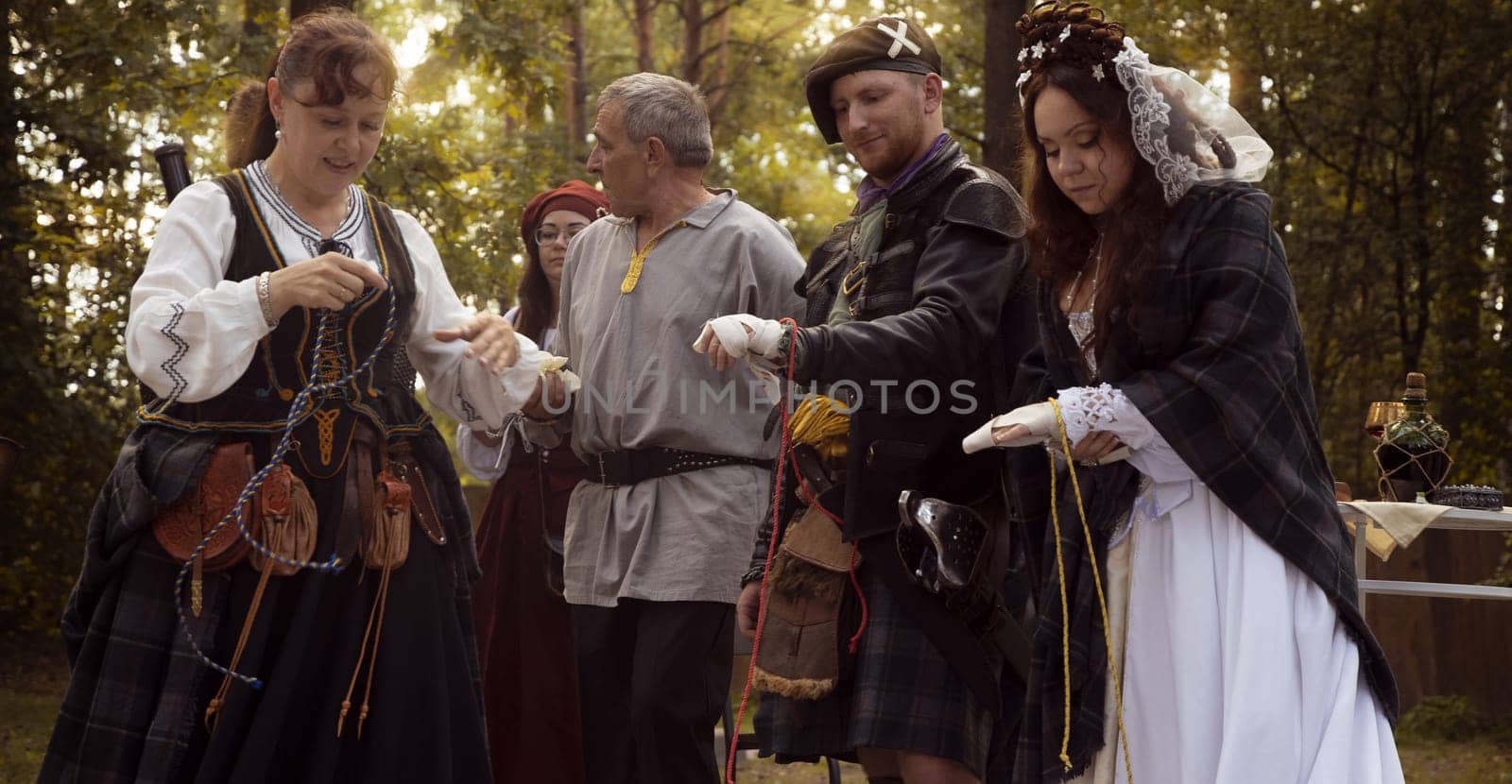 Wedding ceremony. Scottish wedding. Husband and wife are connected by the threads of fate.