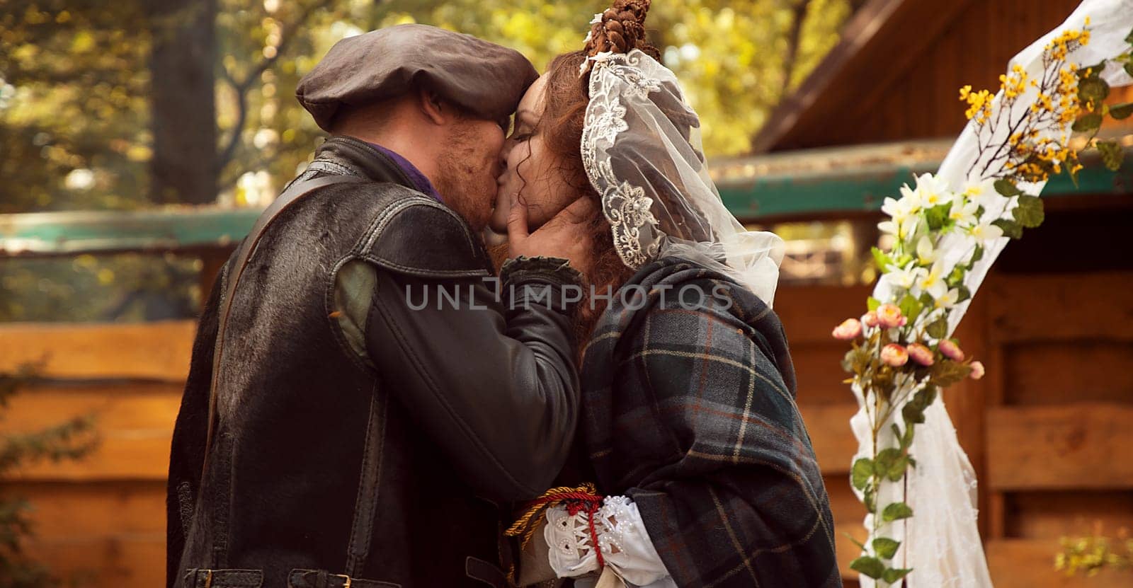 The groom kisses his bride. Scottish wedding by VeronikaAngo