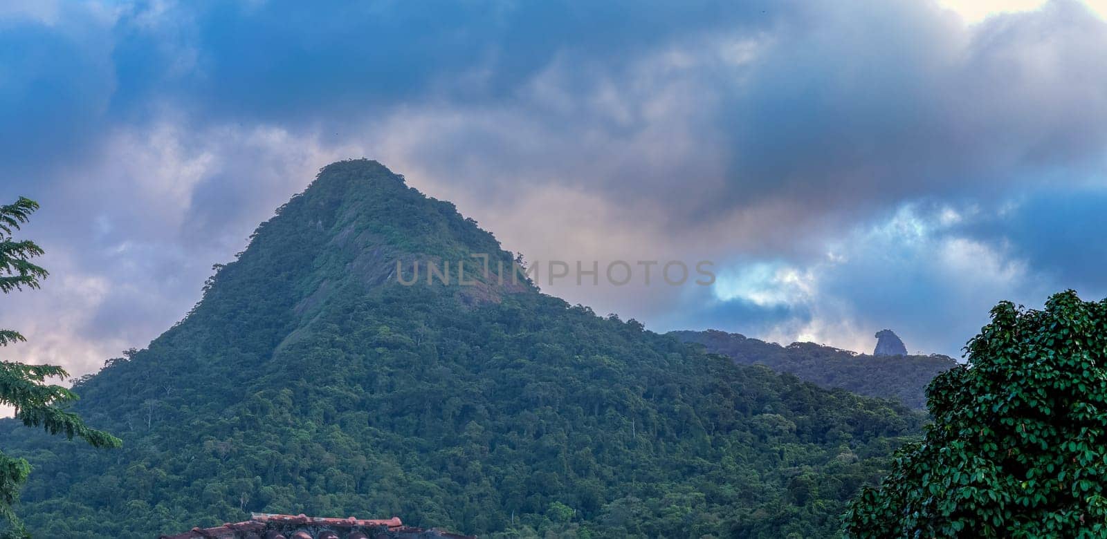 Majestic Green Mountain Under Moody Sky at Twilight by FerradalFCG