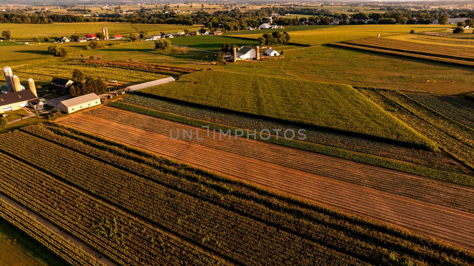 An Aerial View of Rural Farmland and Community at Sunset